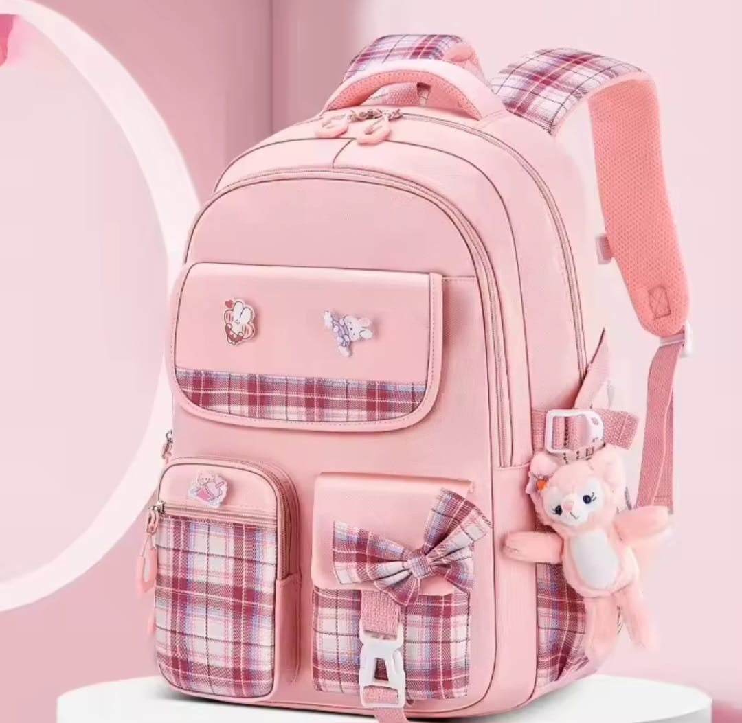 Checkered Student Backpack with plushie and pins.