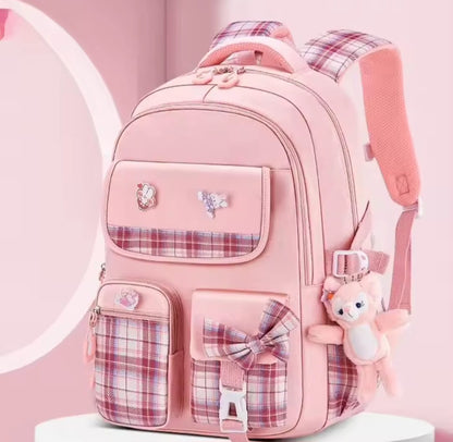 Checkered Student Backpack with plushie and pins.