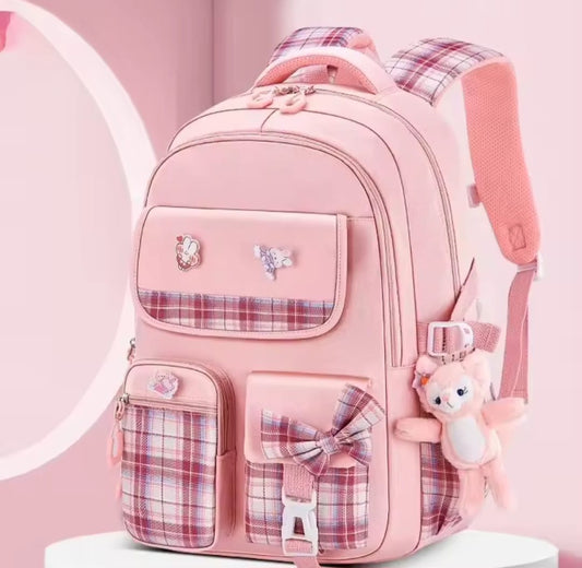 Checkered Student Backpack with plushie and pins.