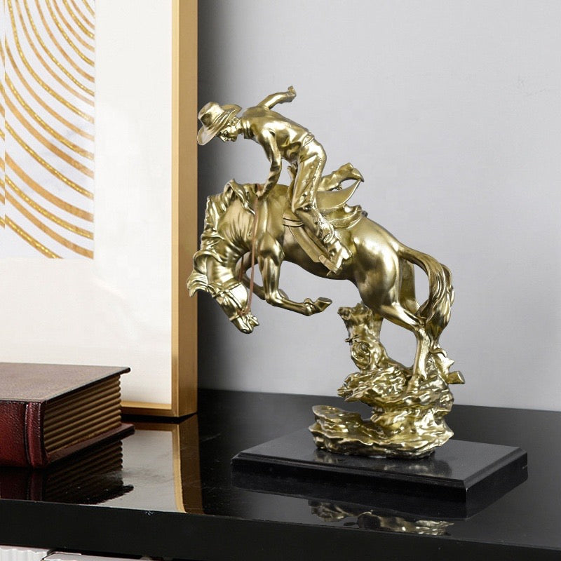 COWBOY RIDING HORSE STATUE