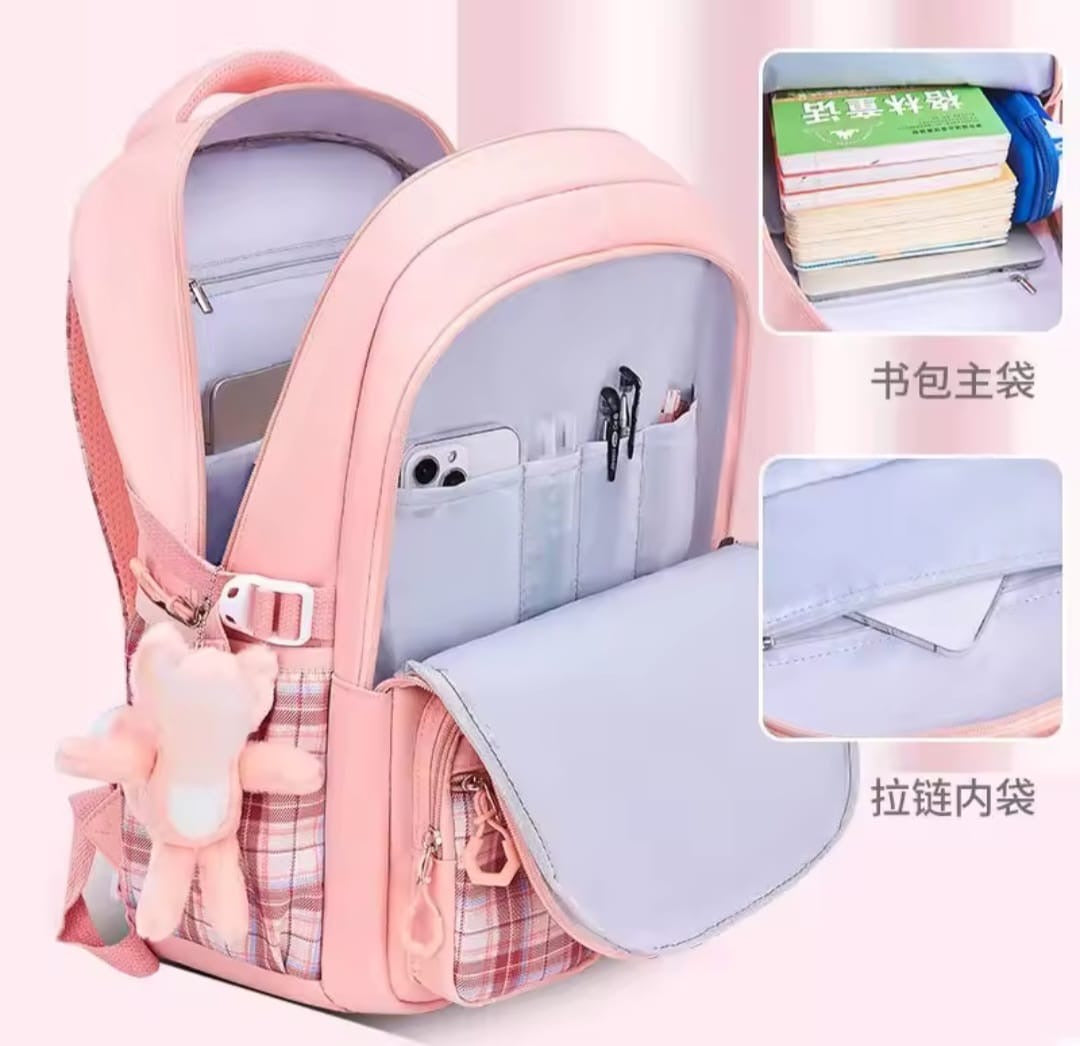 Checkered Student Backpack with plushie and pins.