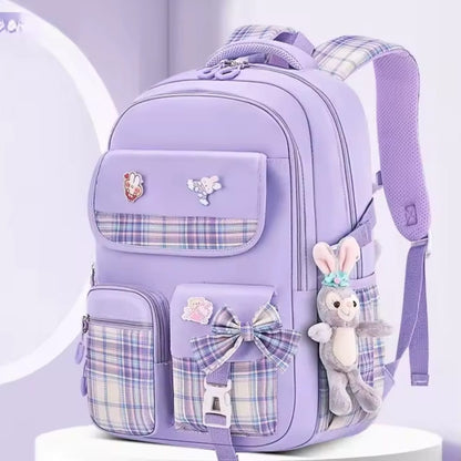 Checkered Student Backpack with plushie and pins.