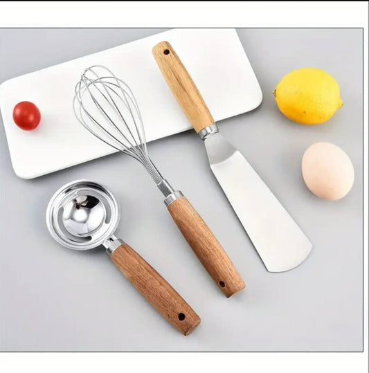 Stainless kitchen accessories with wooden handles.