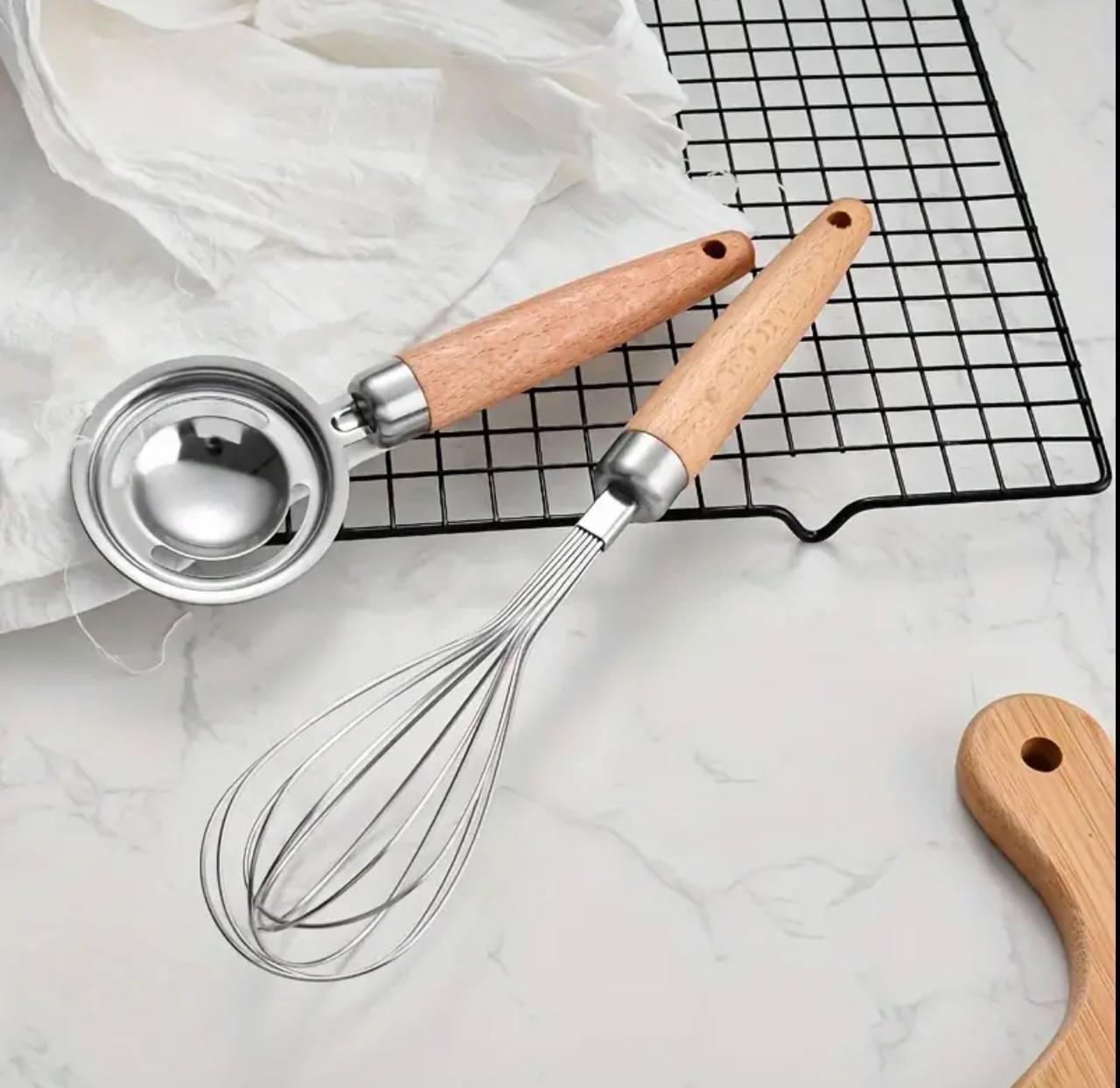 Stainless kitchen accessories with wooden handles.