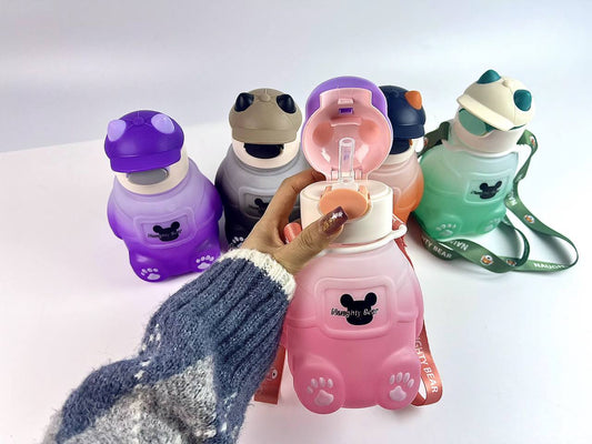 Adorable bear-shaped bottle with a stylish hat or headphone design, sturdy build, and matching strap.